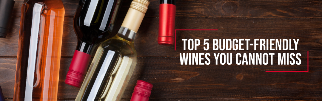 Bottles of red, white and rose wine lying on a wooden table with loose capsules, with the title Top 5 budget friendly wines you cannot miss