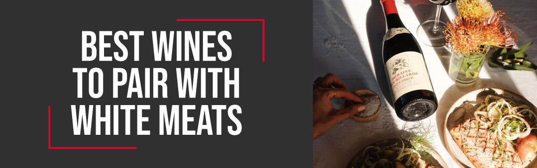 Bottle of red wine beside a served plate of white meat on a laid table, with the title Best wines to pair with white meats
