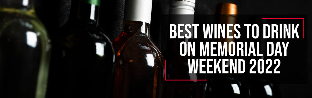 Row of wine bottles in low light, with the title Best wines to drink on Memorial Day weekend 2022